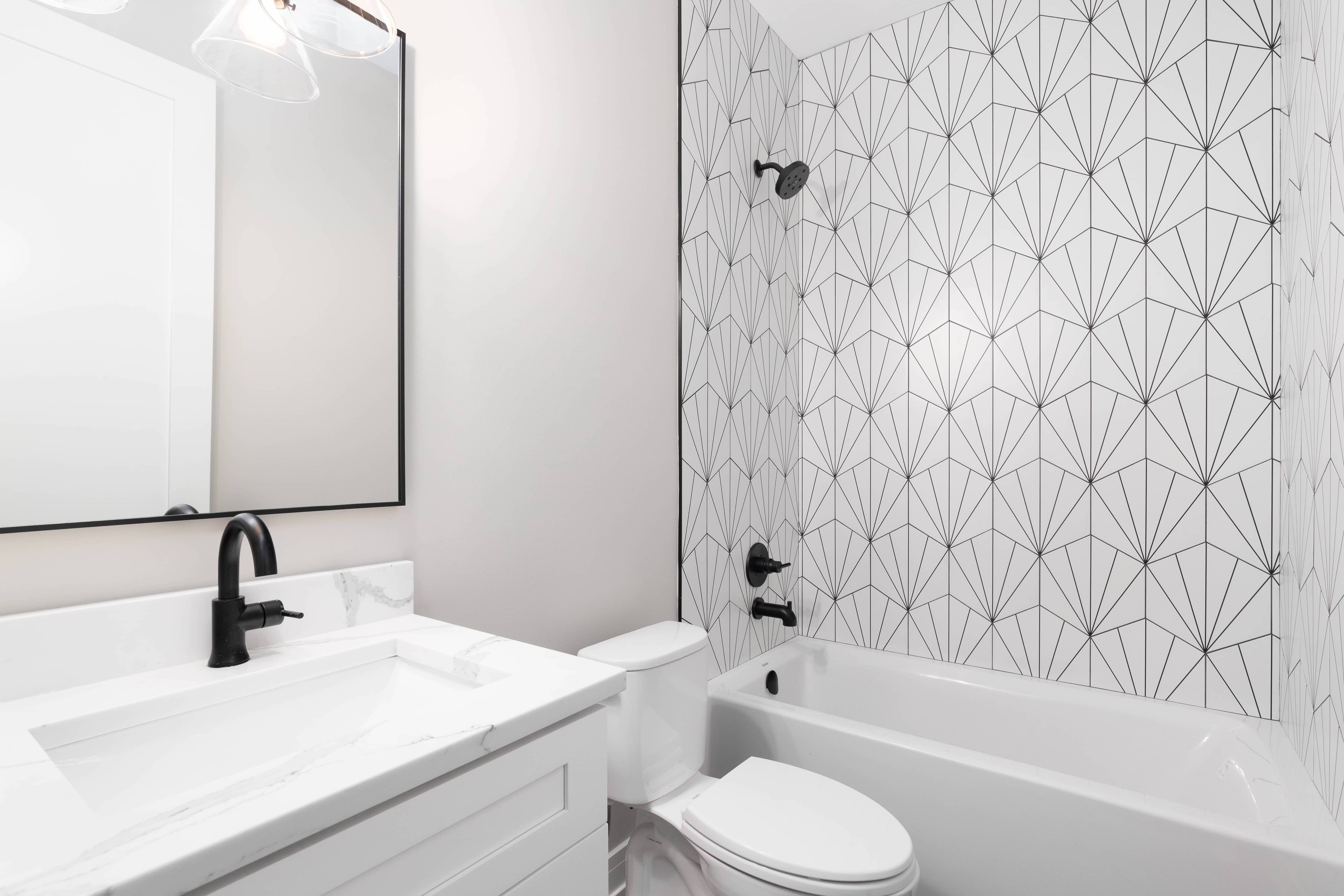 White patterned tiling in shower with black grout