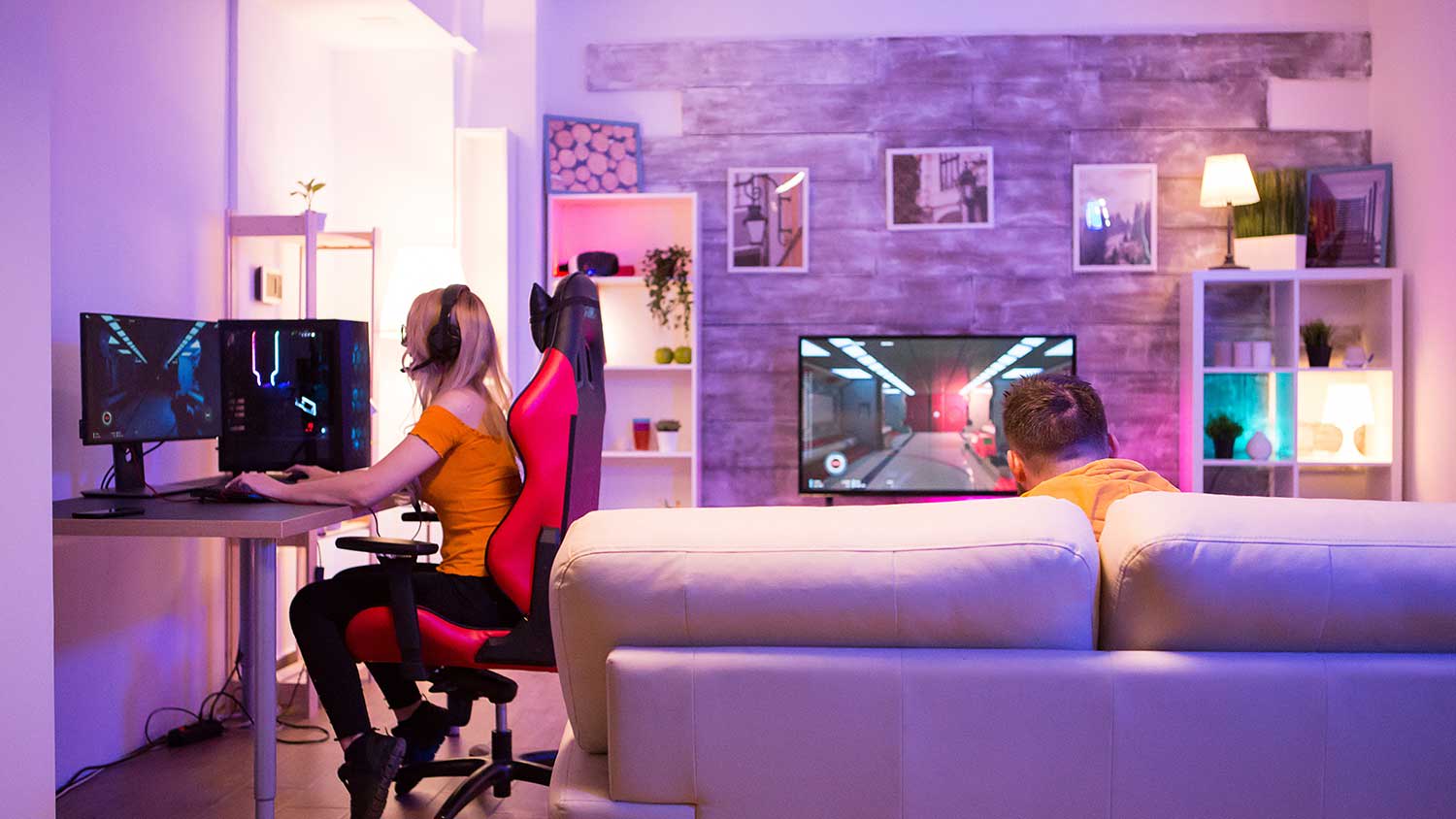 Teenagers playing video games in game room