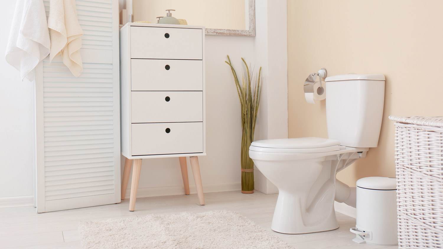 A white toilet bowl in a bright bathroom