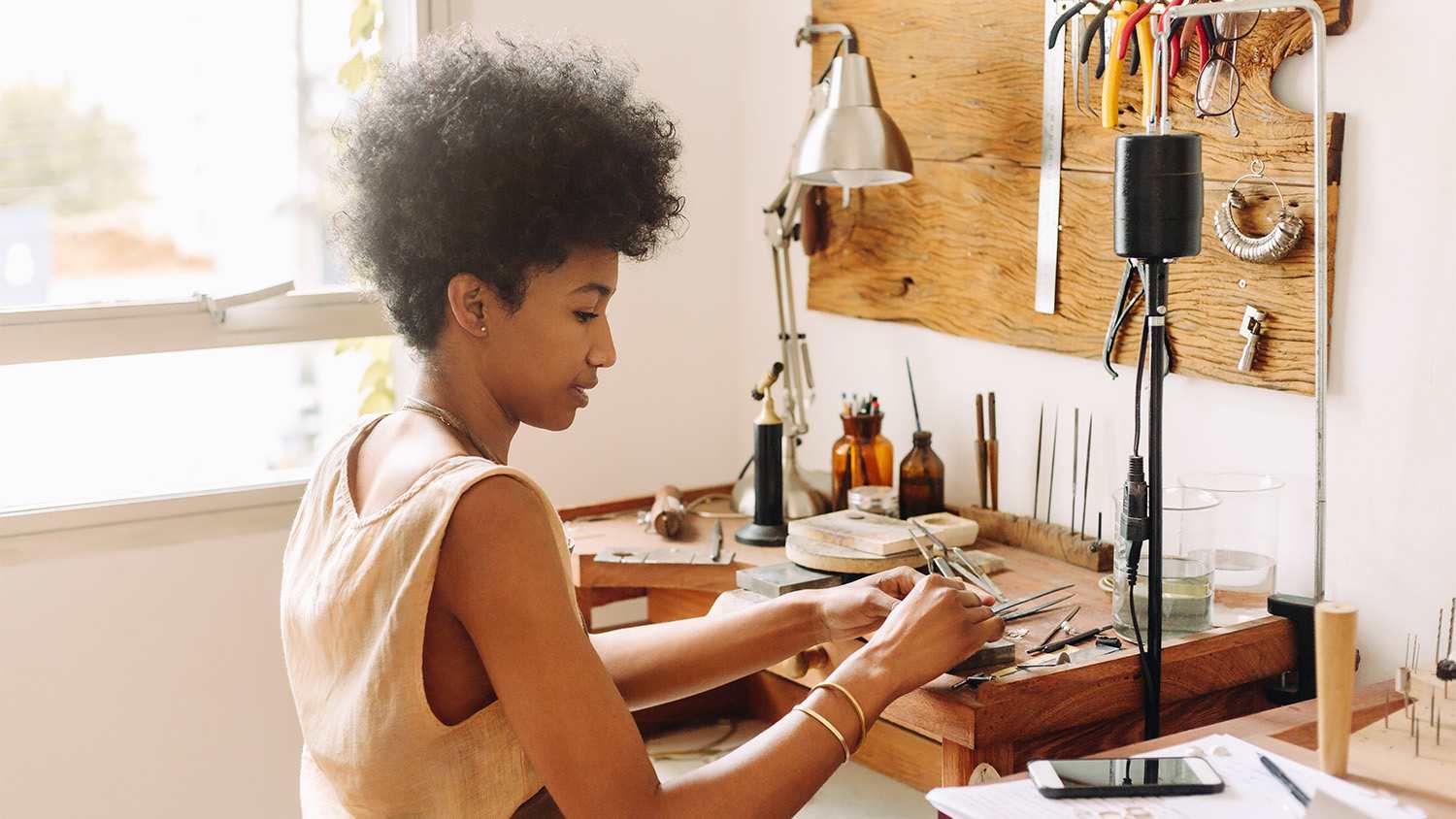 woman using her tools at her workbench