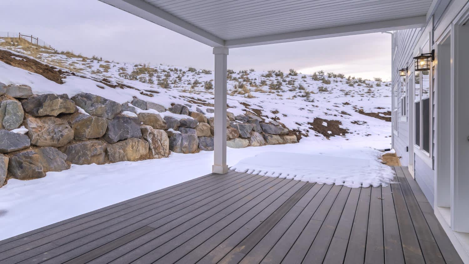 A large covered porch with wooden deck