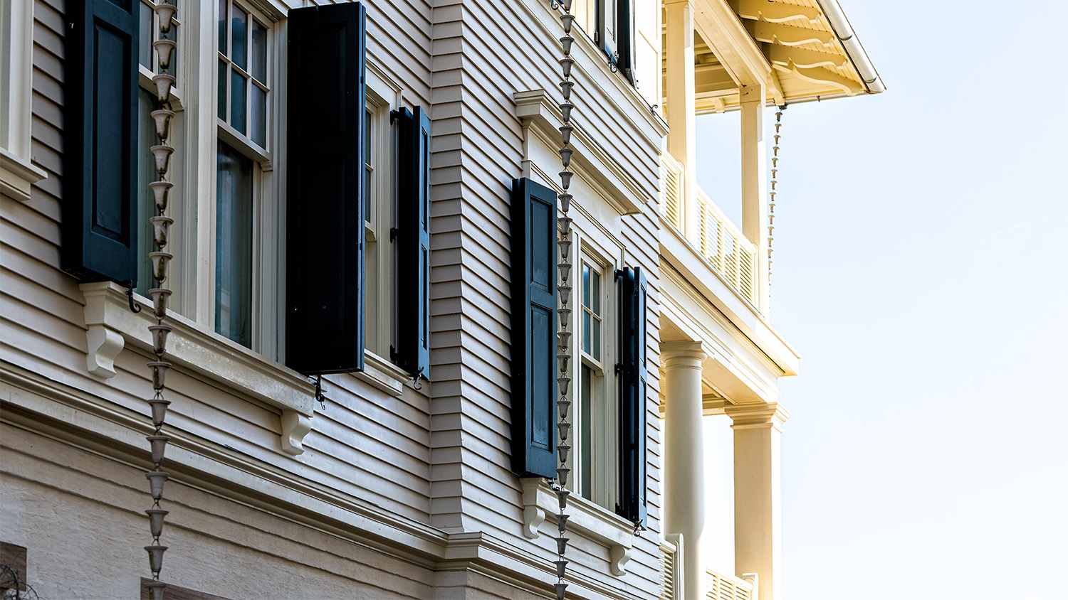 beige home with rain chain