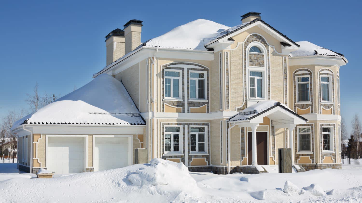 Light cottage with garage at frosty and sunny winter