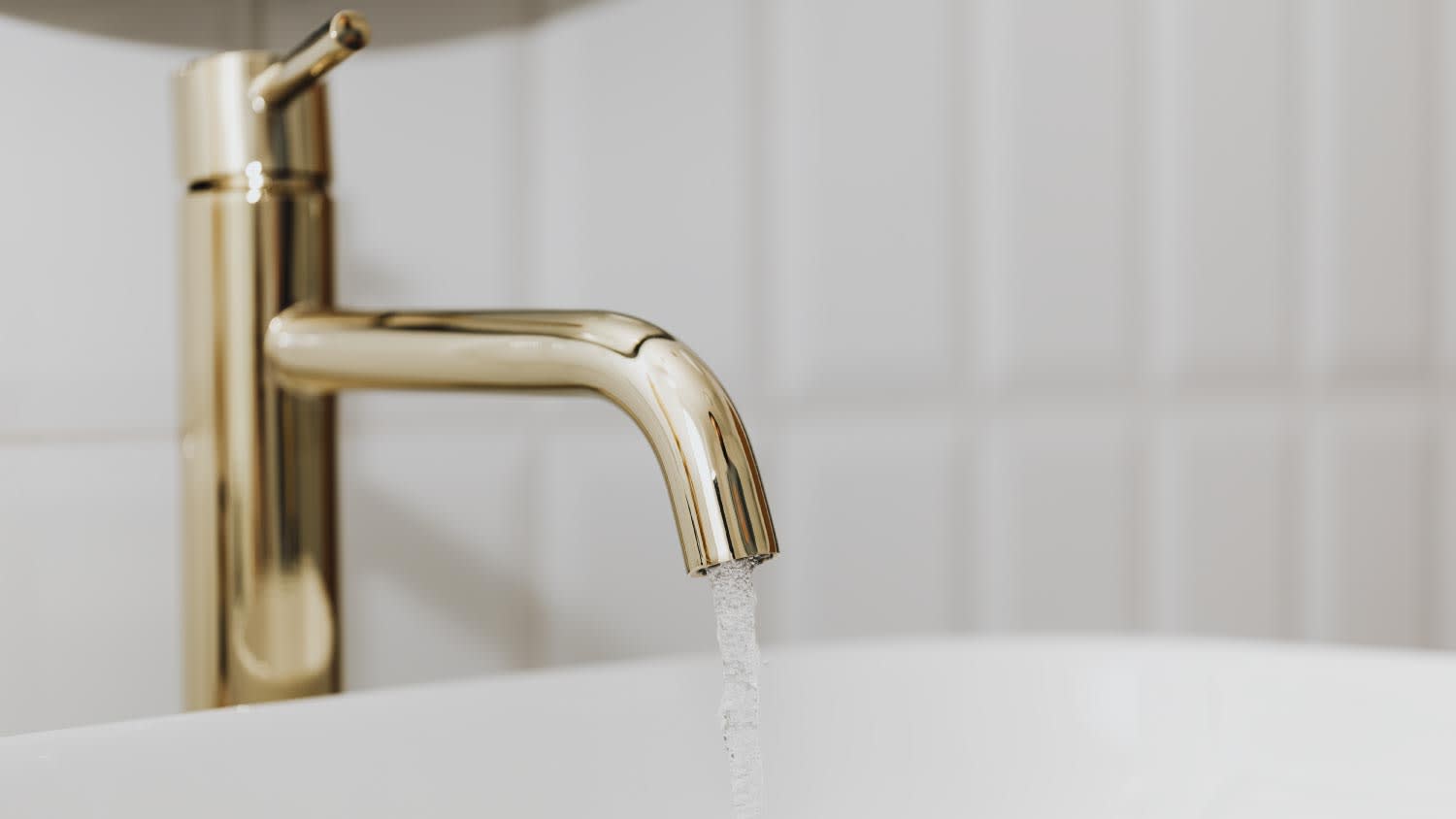 Golden faucet with running water