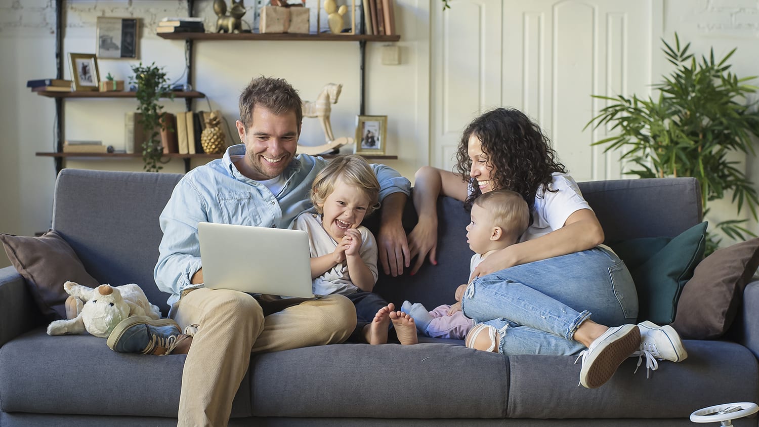a multi-generational and diverse family enjoys a bright modern living room at home