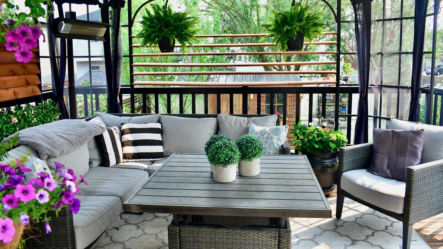 A lanai patio with a sitting area facing the backyard