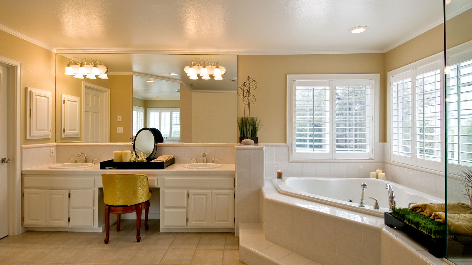 A large bathroom with a vanity and the lights attached to the mirror