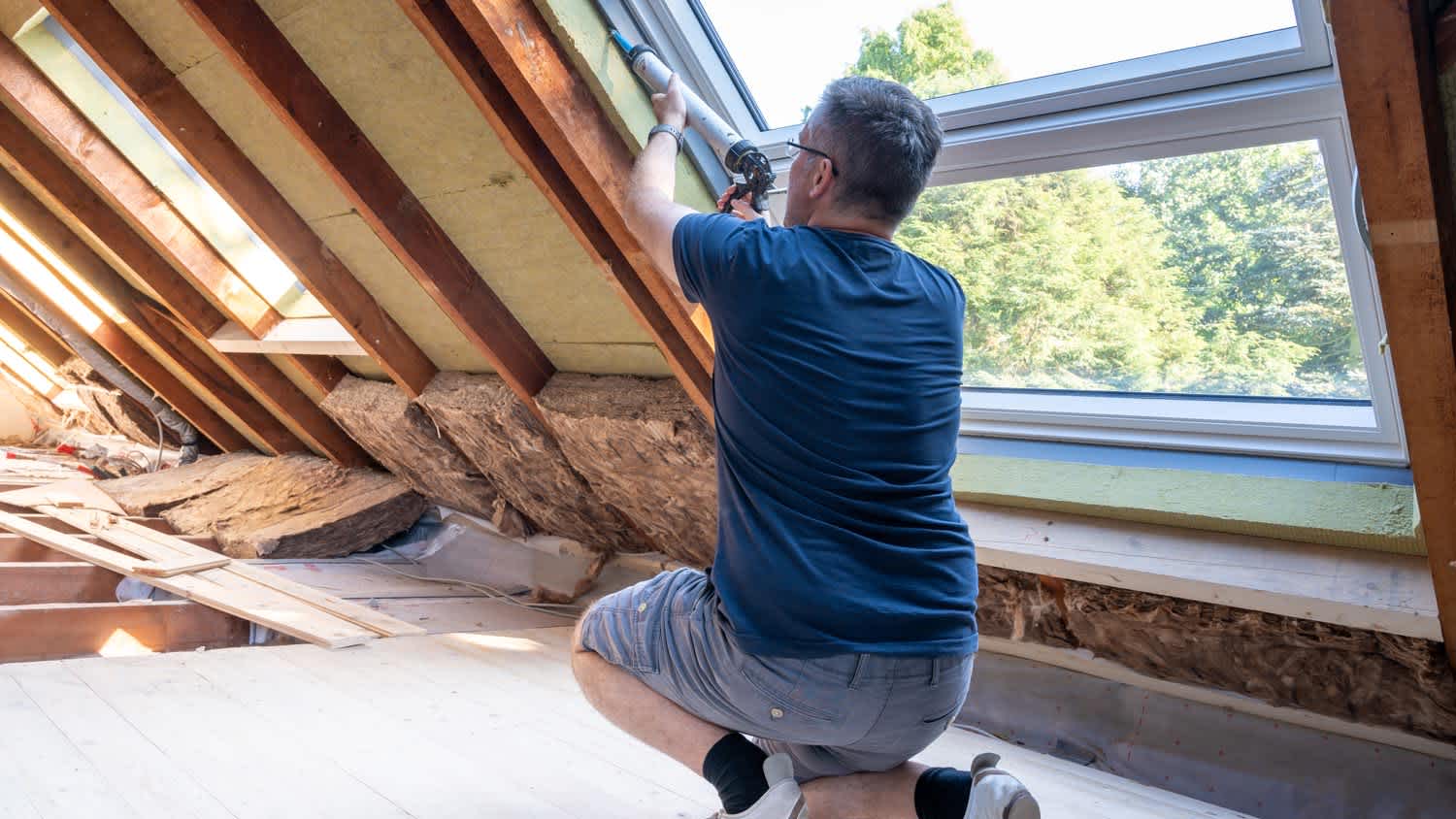 A worker insulating an attic