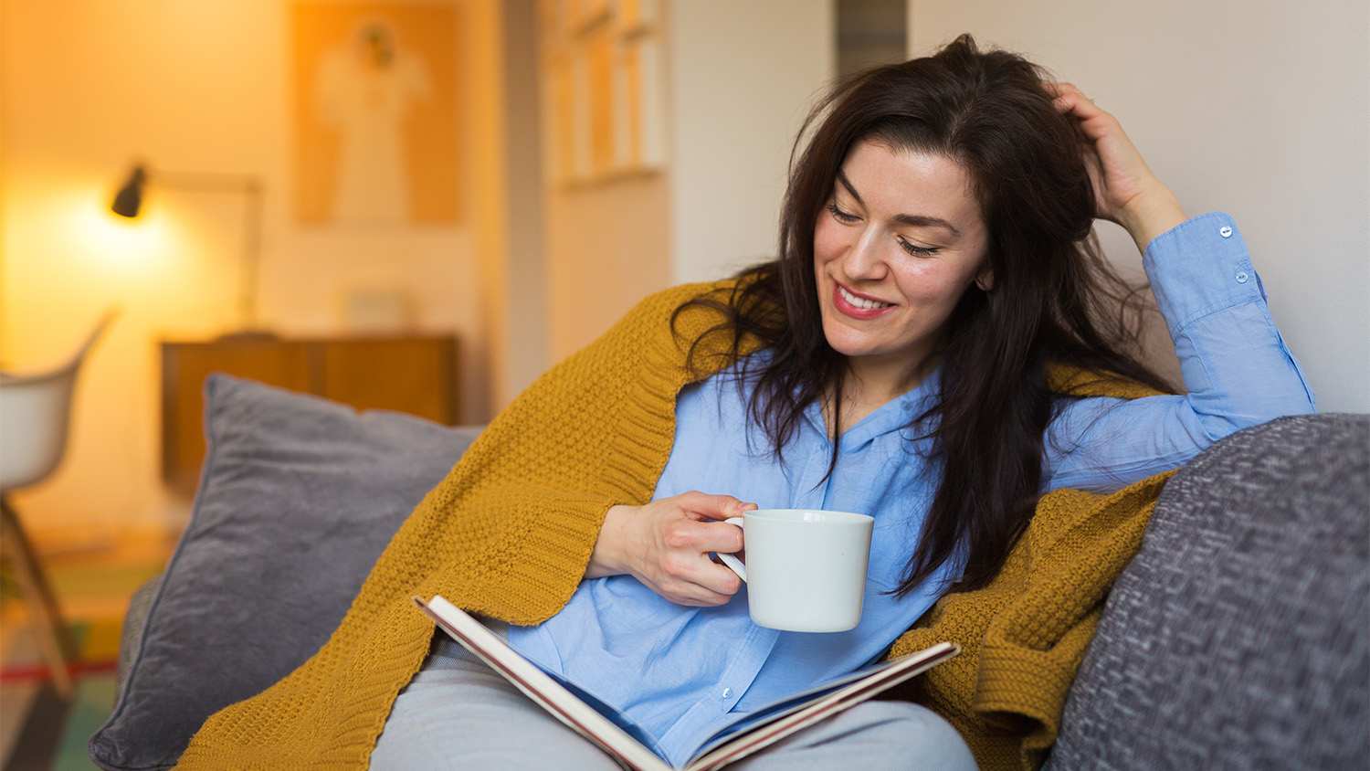 woman cozy at home reading a book