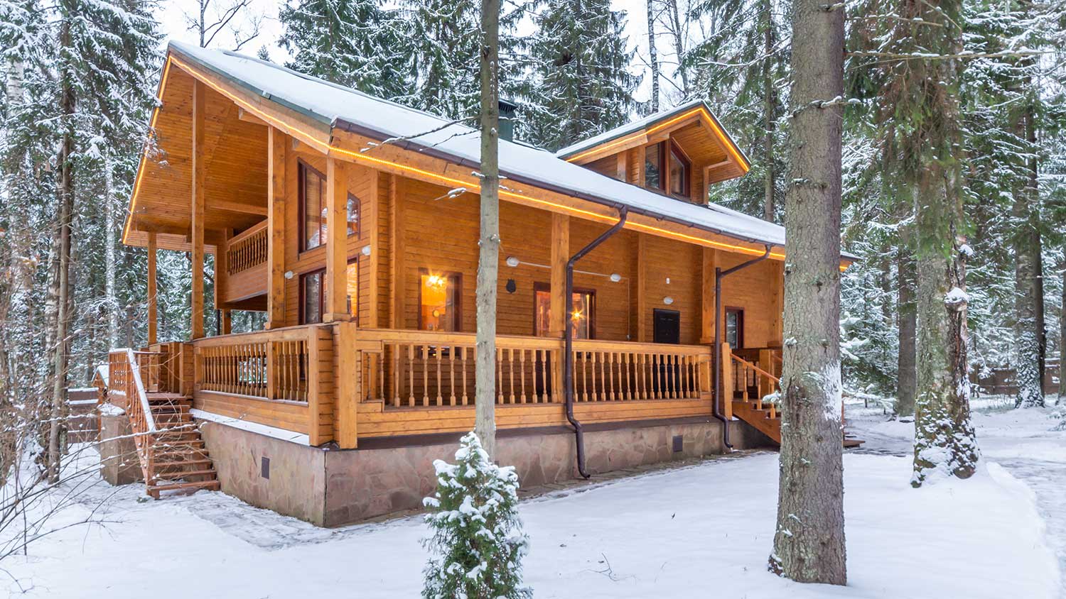 Snow covered cabin in the forest
