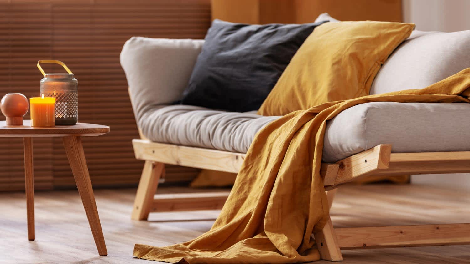 A futon with black and orange pillows