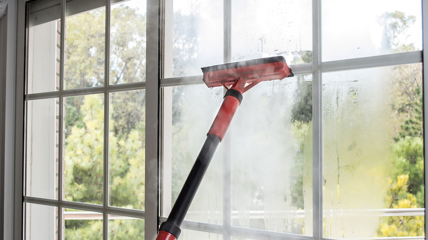 Cleaning window glass with steam cleaner