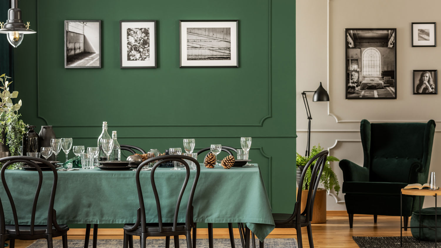 A dining room with a green painted wall