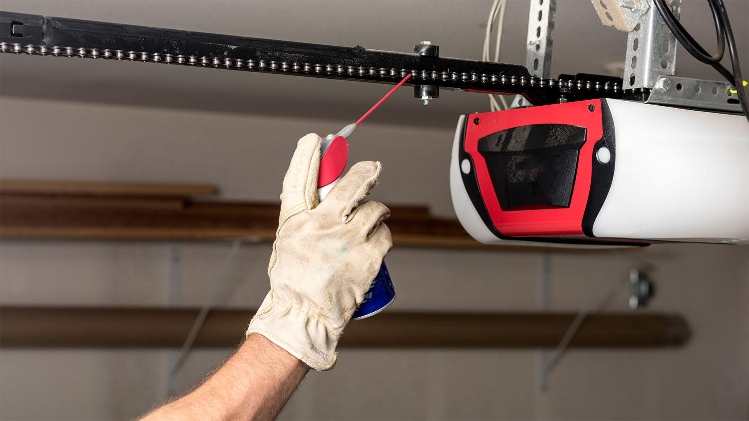 Applying oil to a chain of a garage door