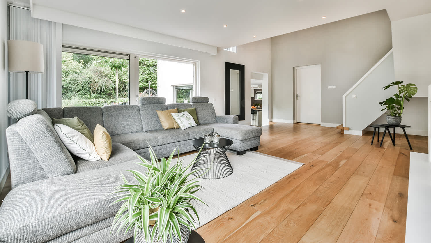 spacious interior living room design with grey sofa