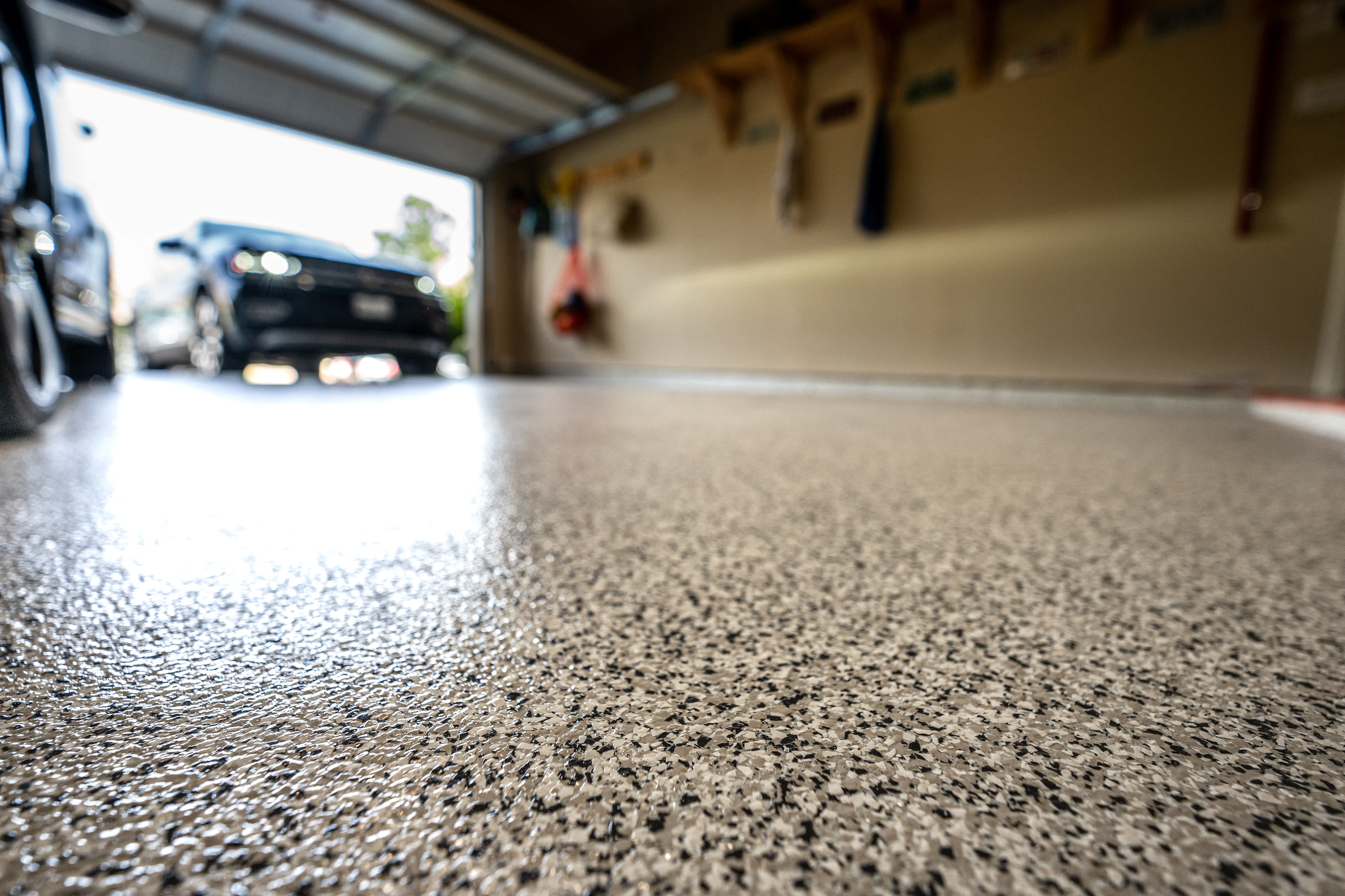 A car pulling into a garage with an epoxy floor
