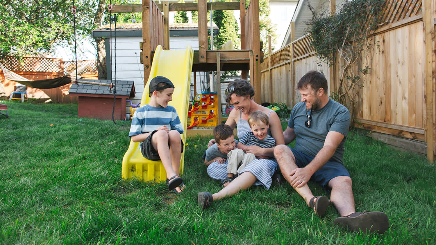 Family hanging out together in the back yard on the grass