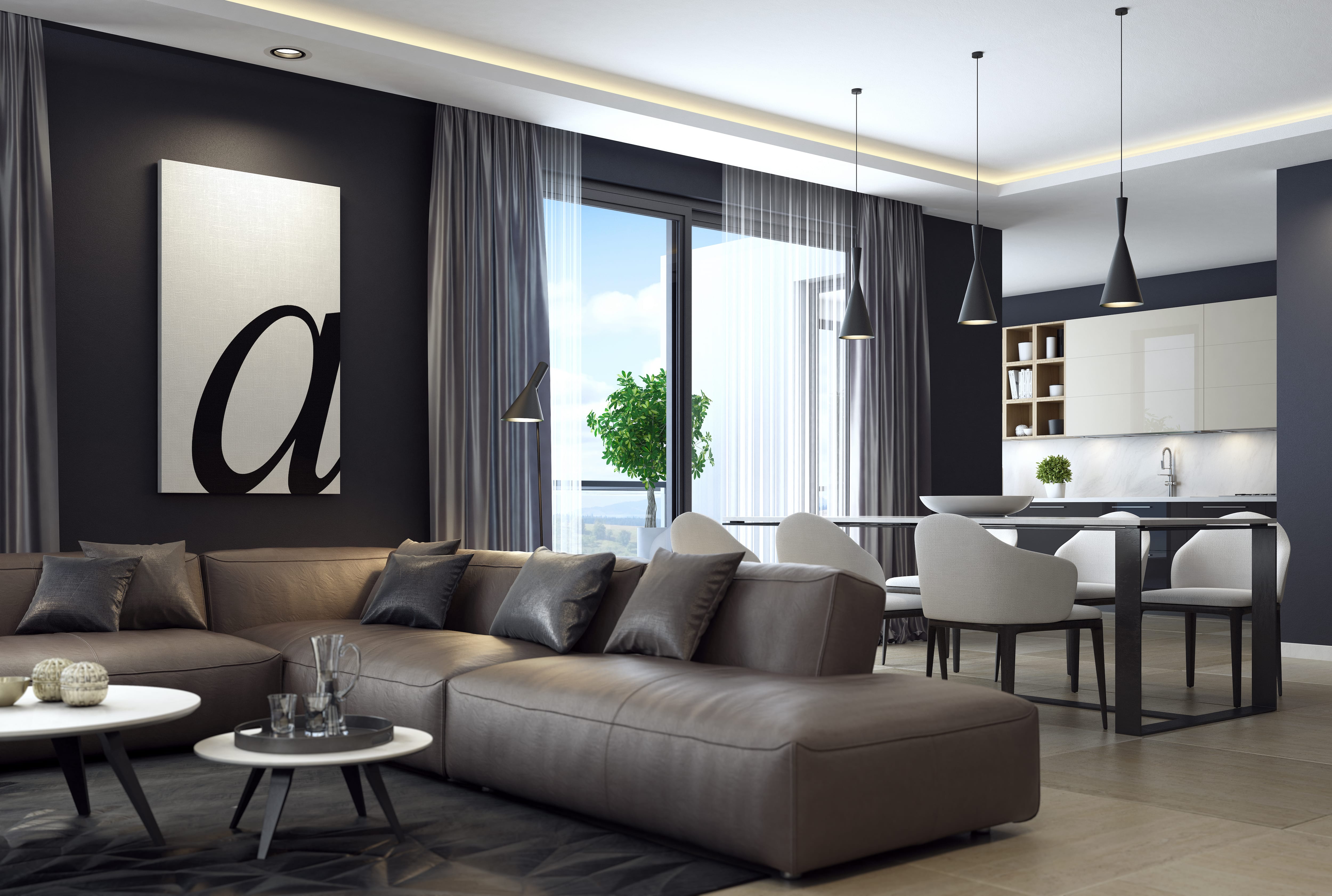 Contemporary living room with black walls and leather furniture next to dining area and kitchen