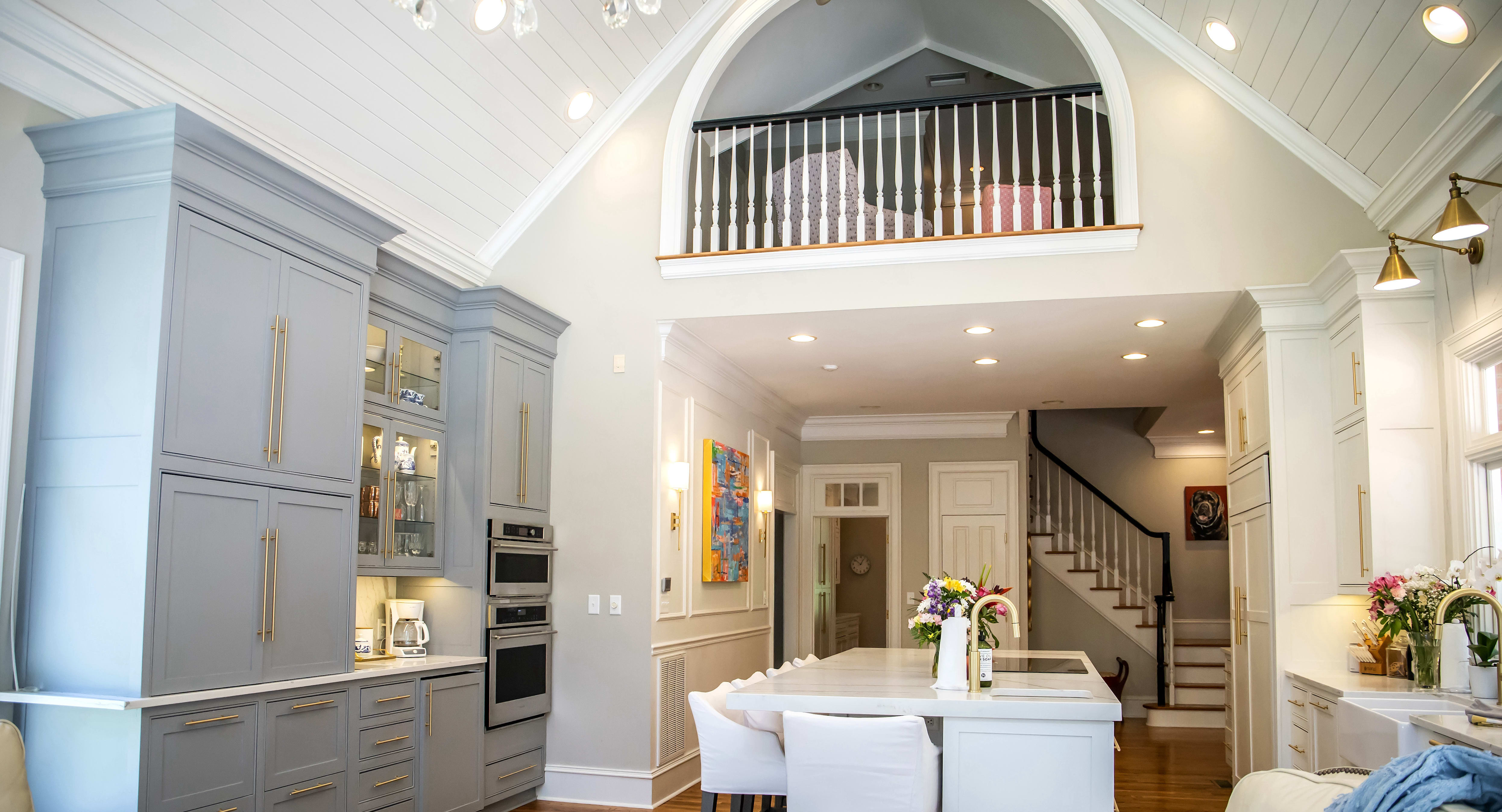 pen concept kitchen and living room with kitchen island, upper loft, and shiplap ceiling