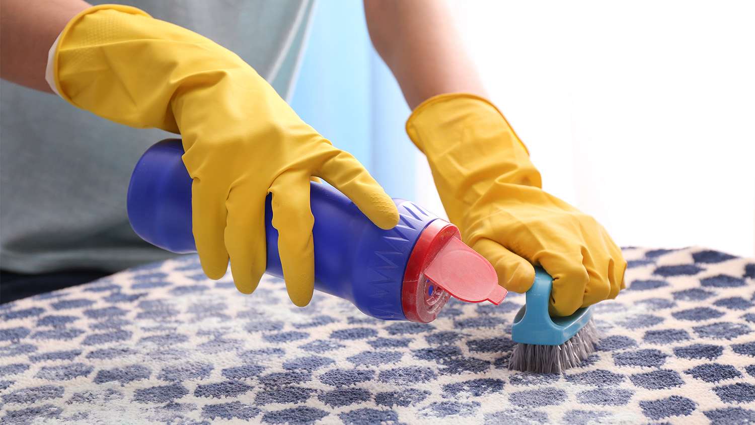 close up woman cleaning carpet