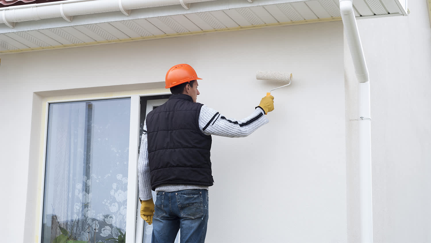 professional paints exterior of house