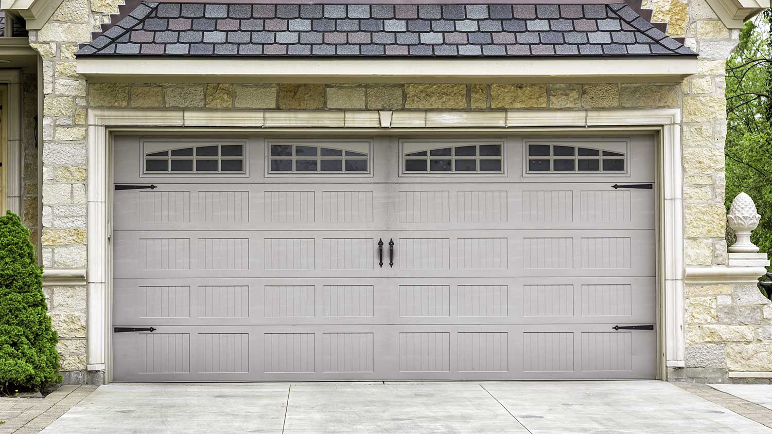 Stone siding house with two car garage