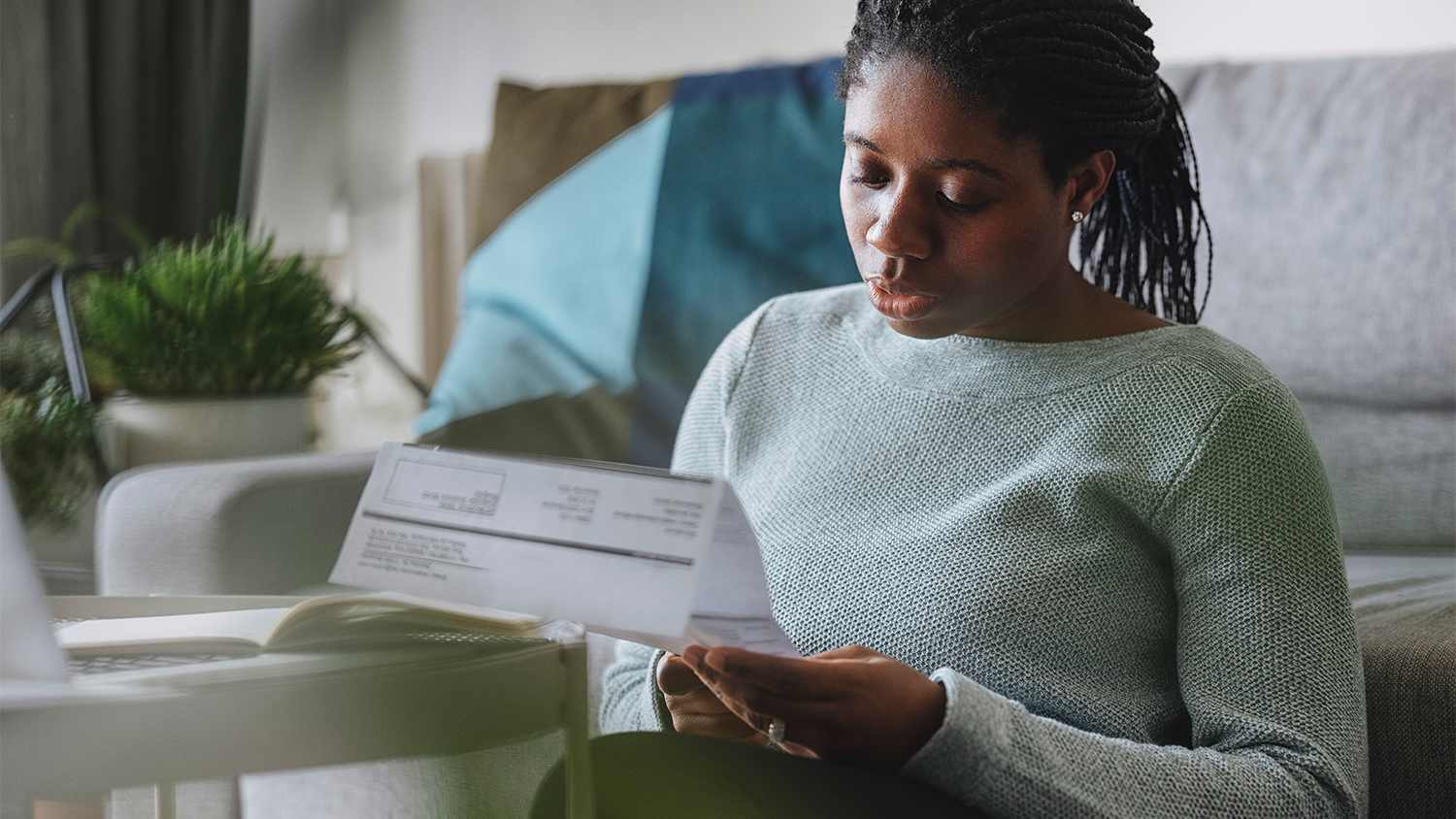 woman going over utility bill at home