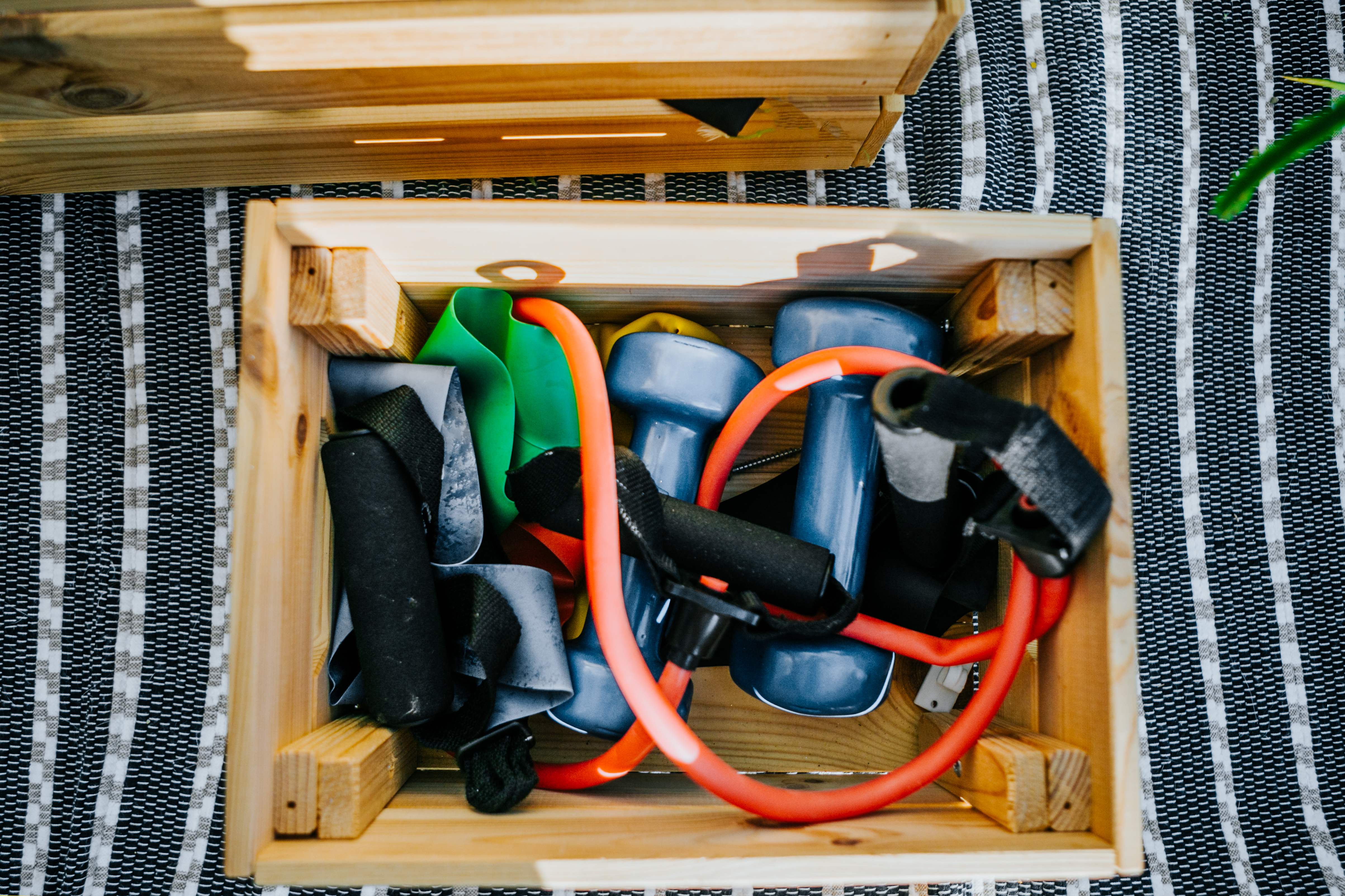 DIY wooden box filled with colorful small gym equipment