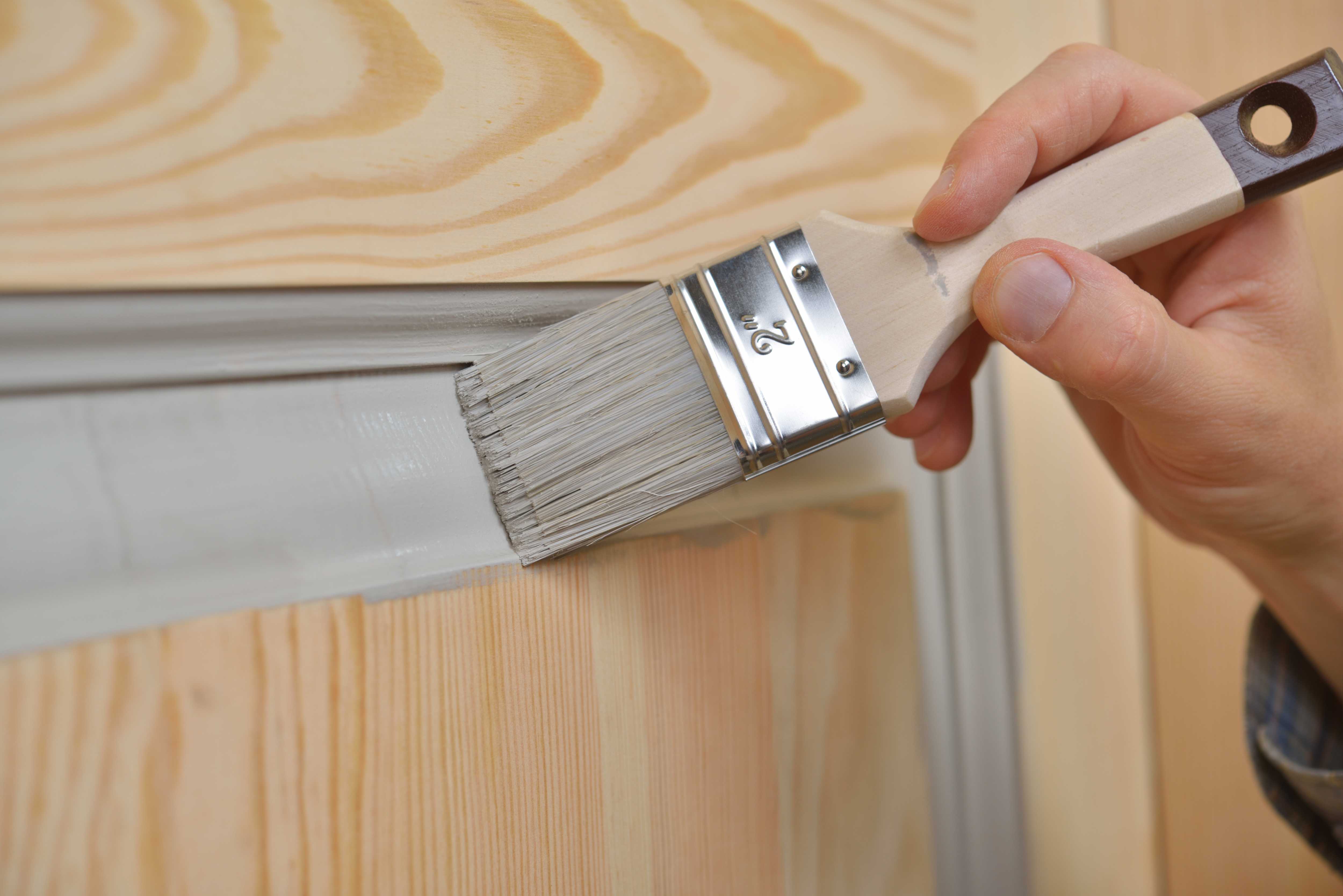 Painting paneled door gray with a paintbrush