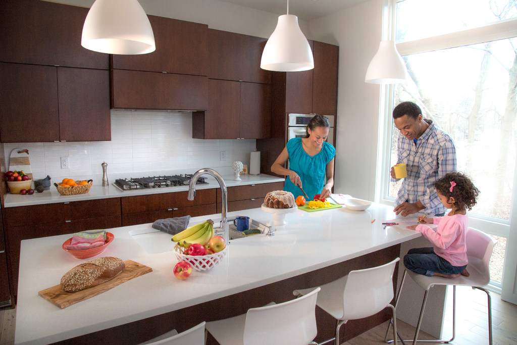 Family enjoys preparing breakfast in kitchen