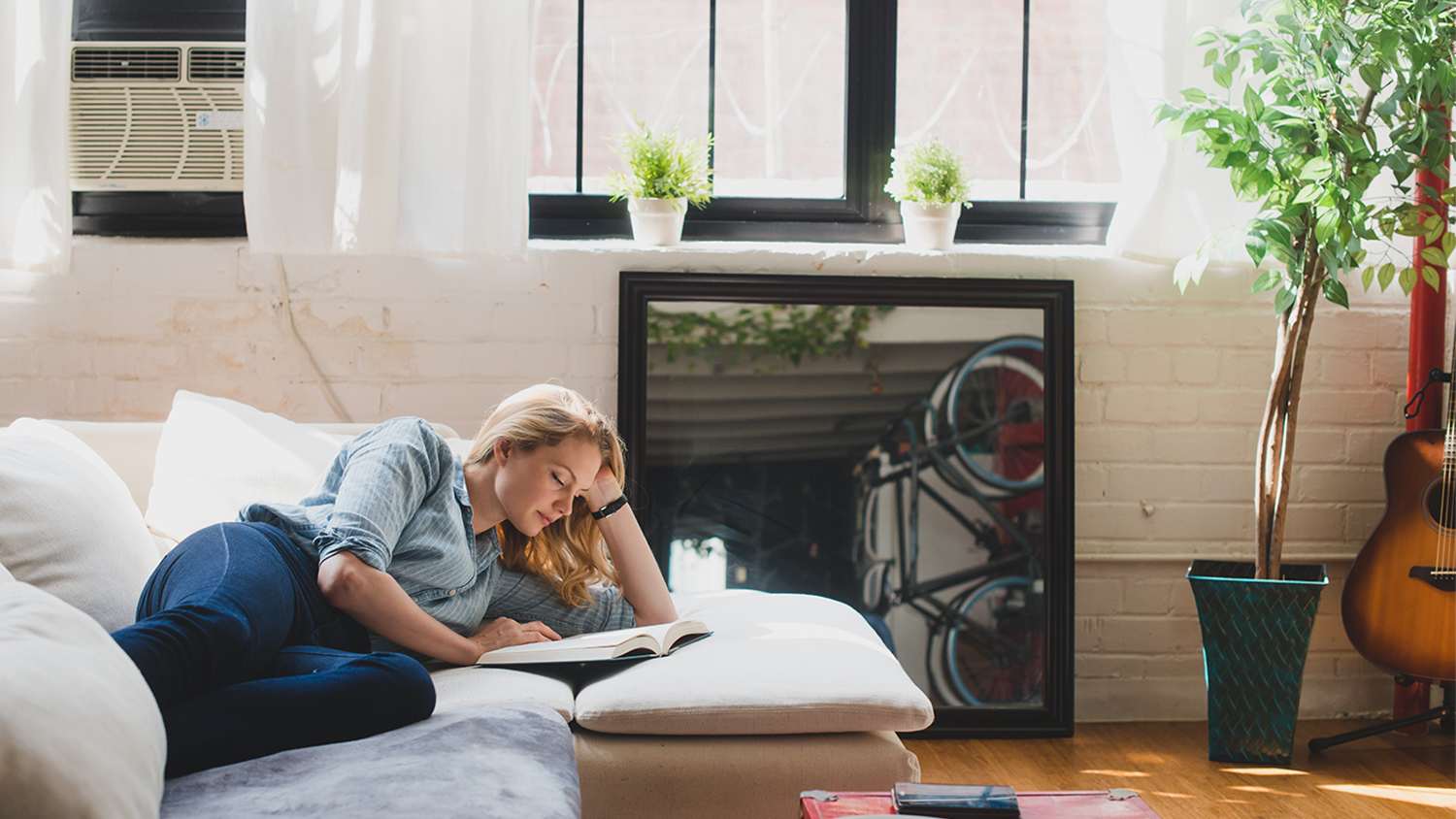 woman laying down on the couch