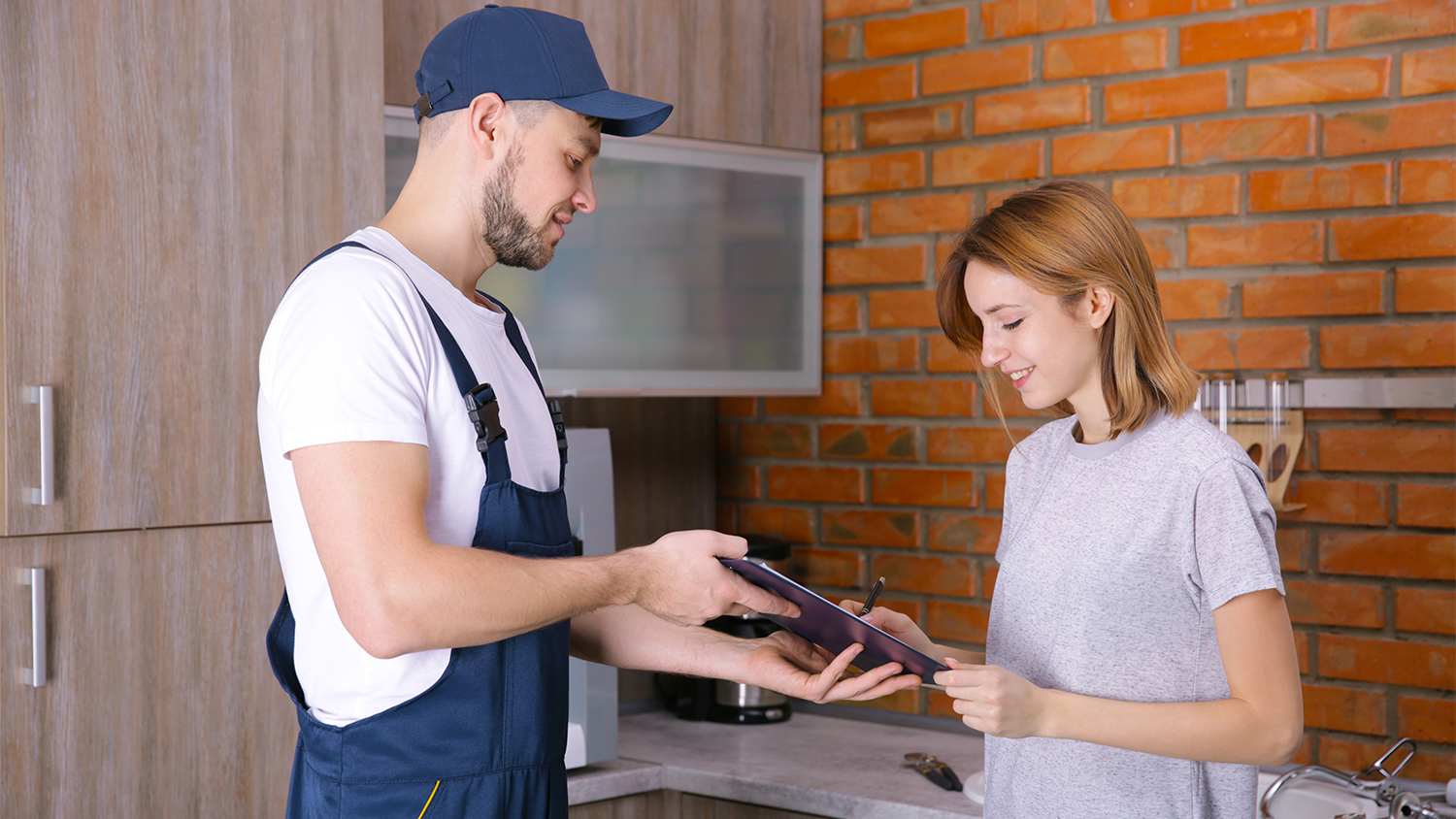 woman signing receipt from contractor