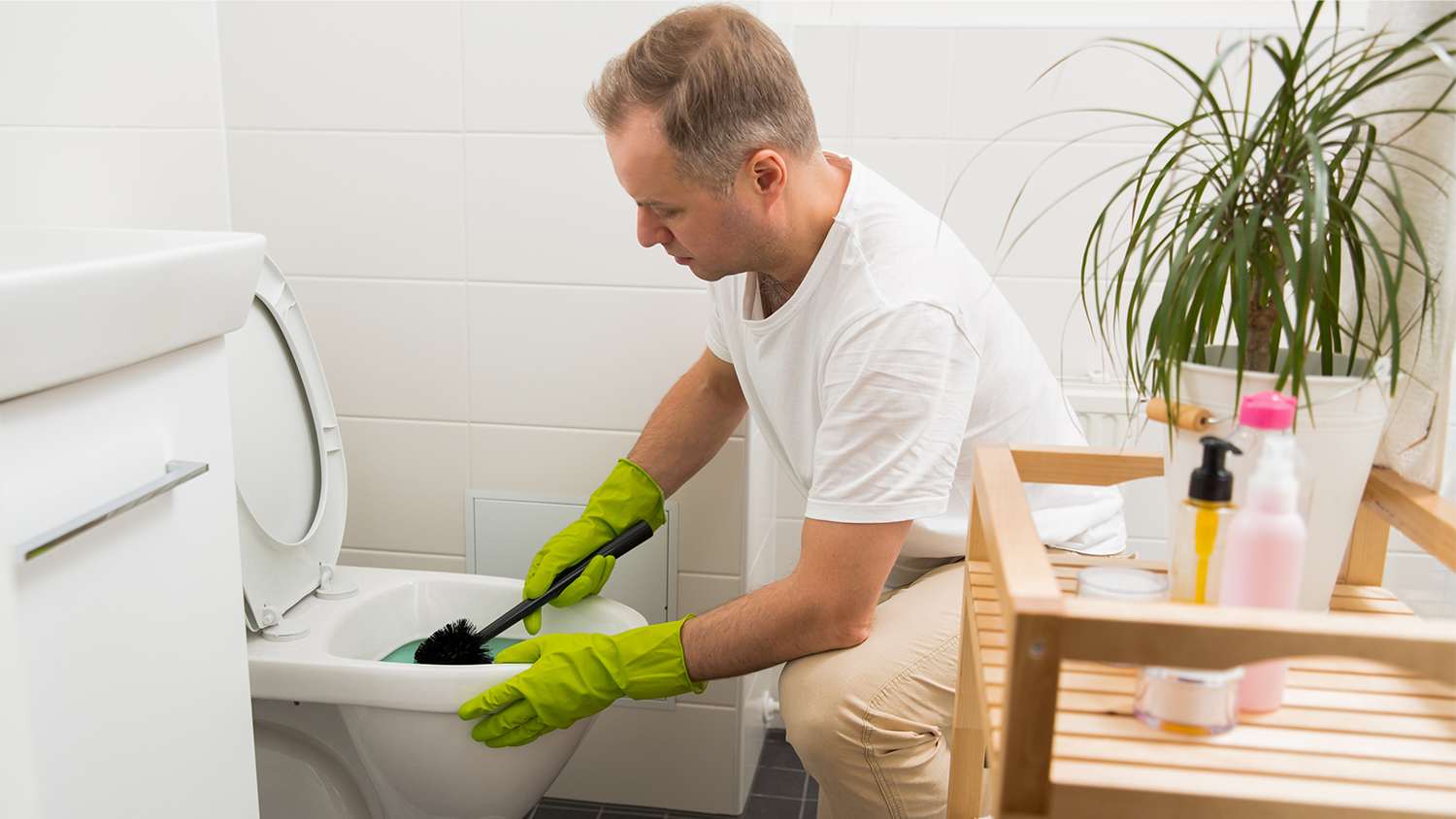 man cleaning his toilet by hand