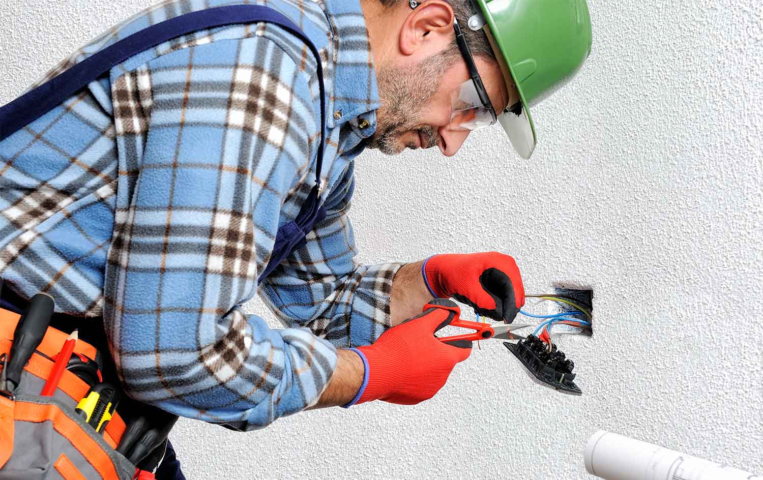 Electrician working on electrical outlet