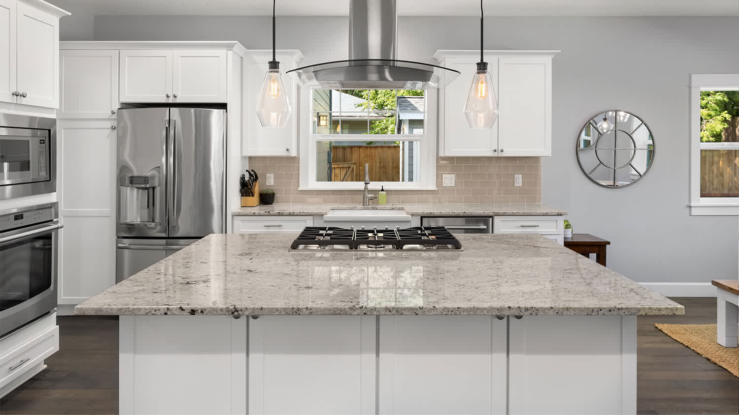 bright new kitchen with beige marble island