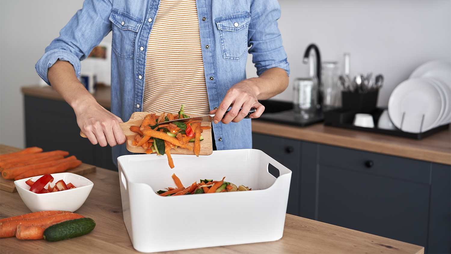 woman gathering scraps for compost