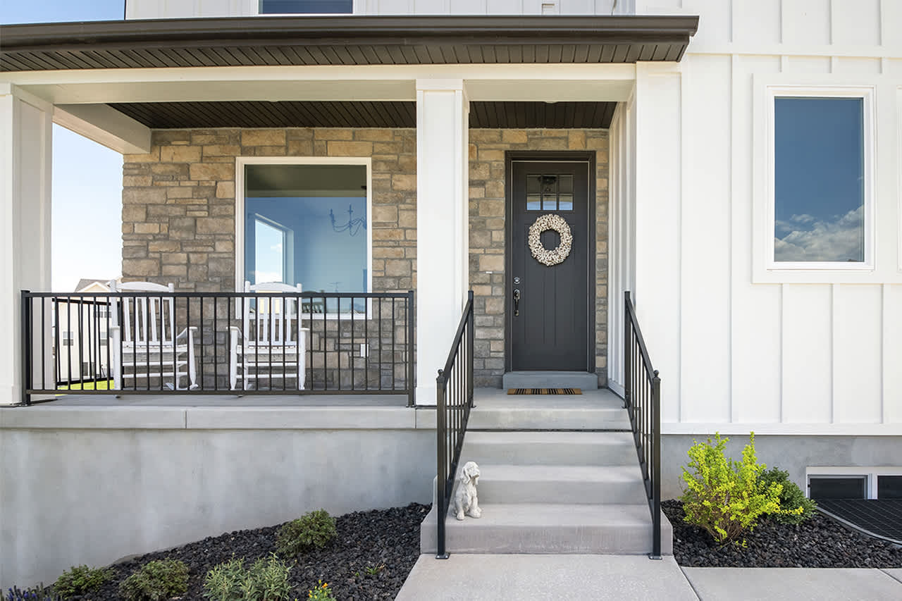house with dark door and railing