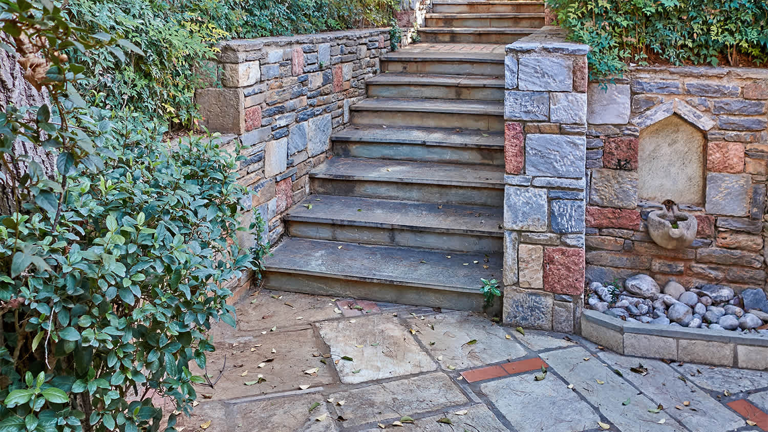 stone decorated entrance with stairs and plants