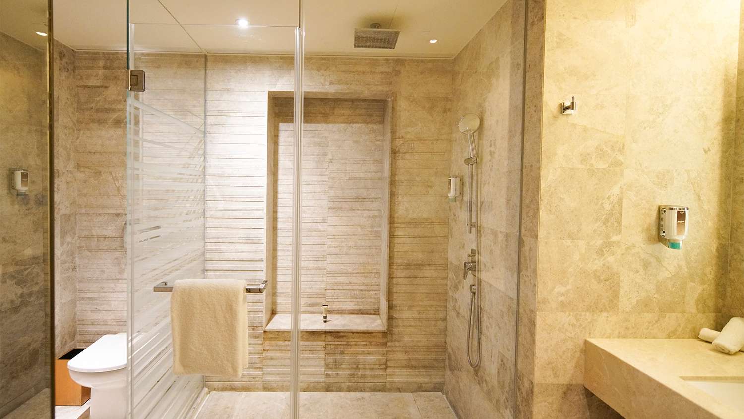 Large bathroom with tiled shower stall