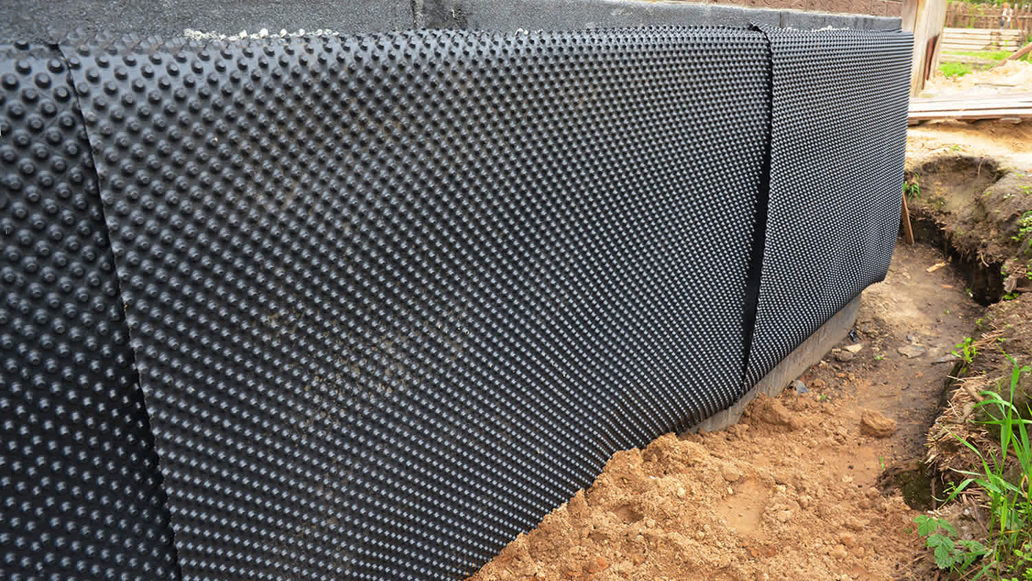 Installation of waterproofing membrane to insulate exterior basement