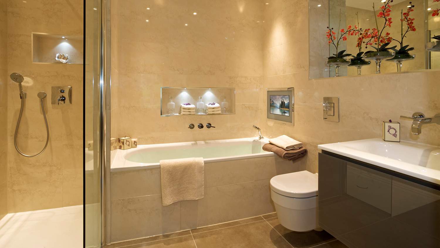 beige relaxing bathroom with built in tv