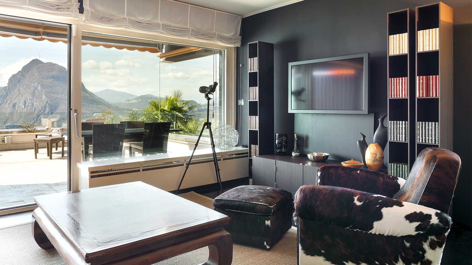 living room with black wall and mounted tv