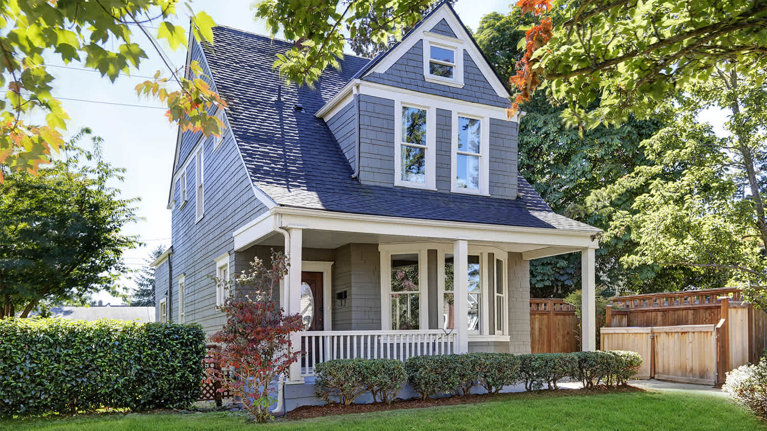 blue and grey house with front yard