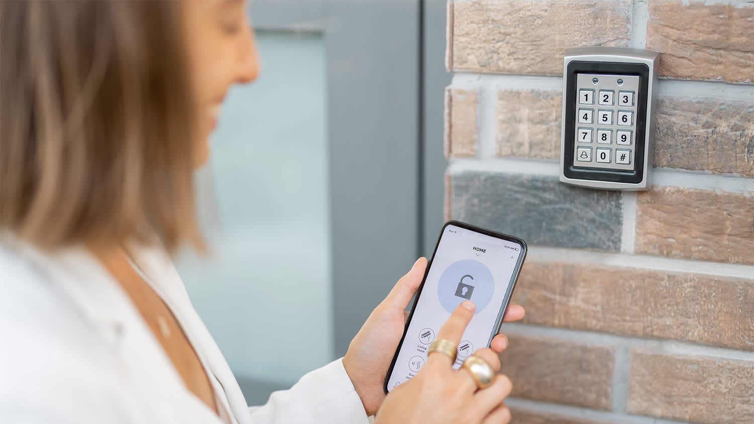 woman using phone to smart lock house