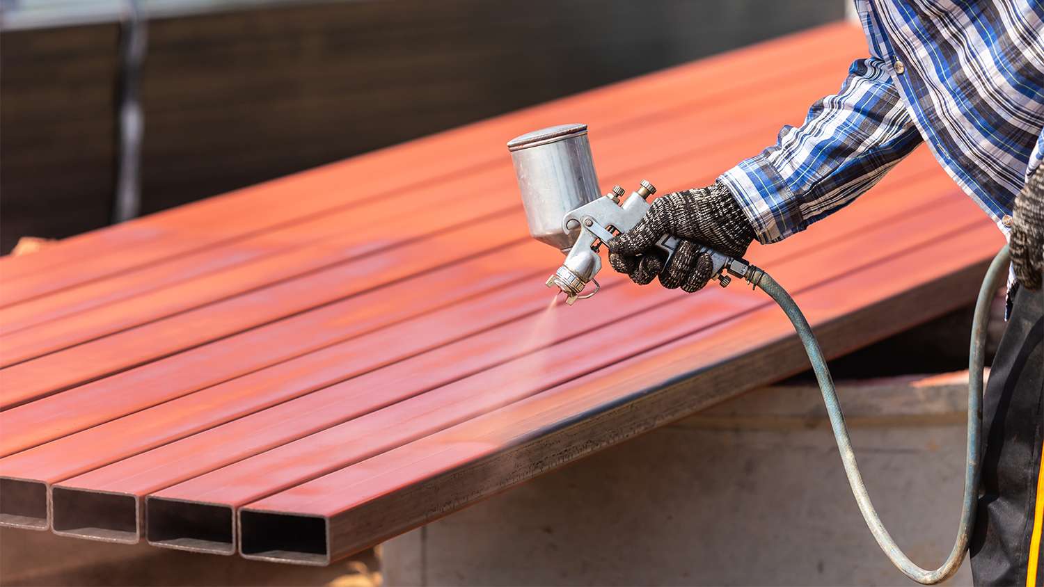 man powder spraying metal