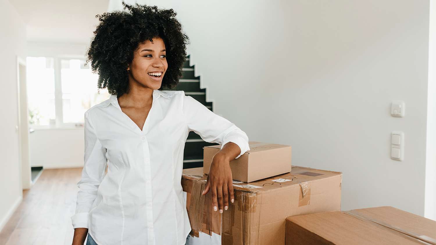 woman moving into new home with boxes