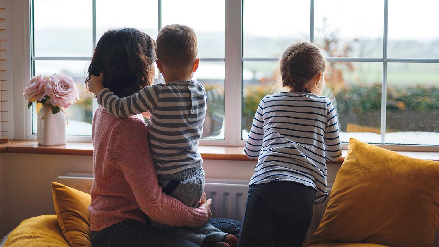 mother with kids looking out the window