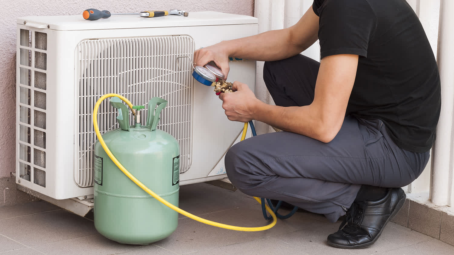 electrician working on refrigerant on ac