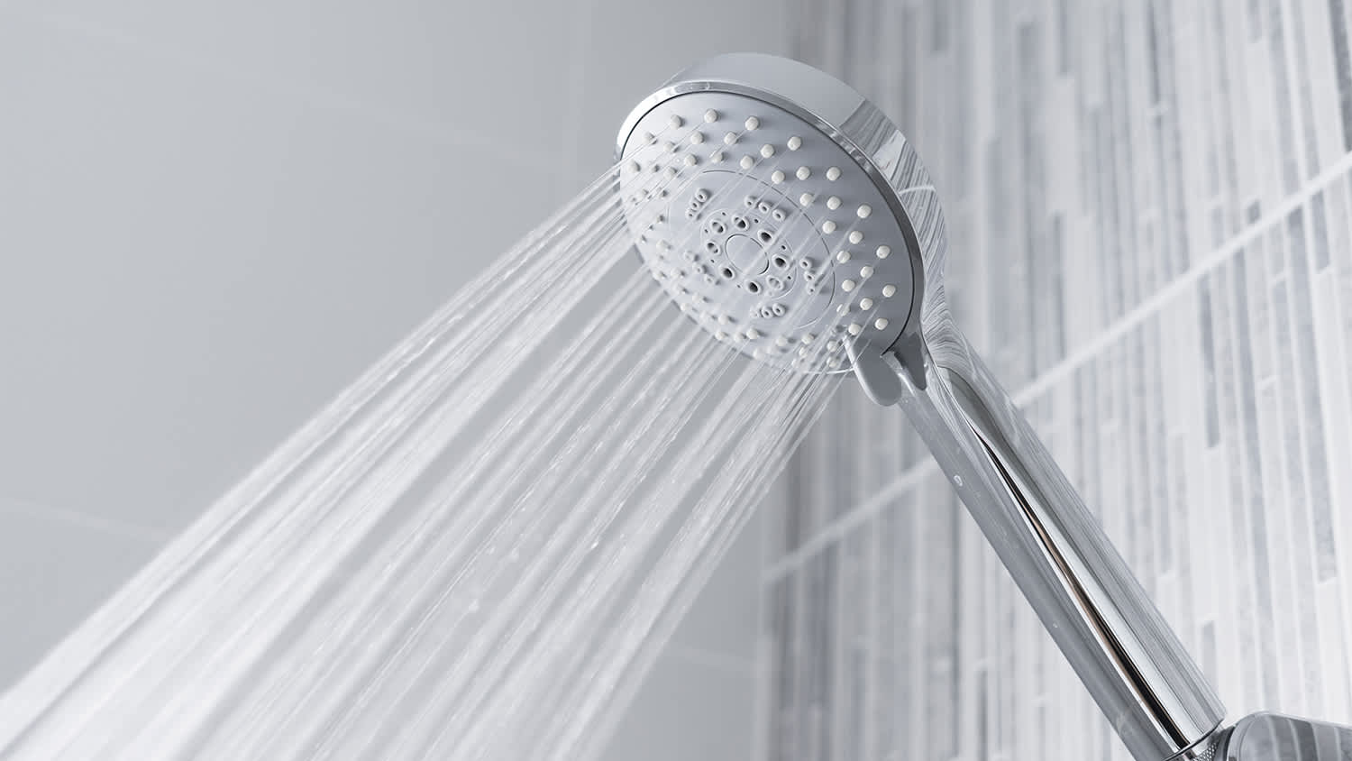 bathroom shower head spraying hard water