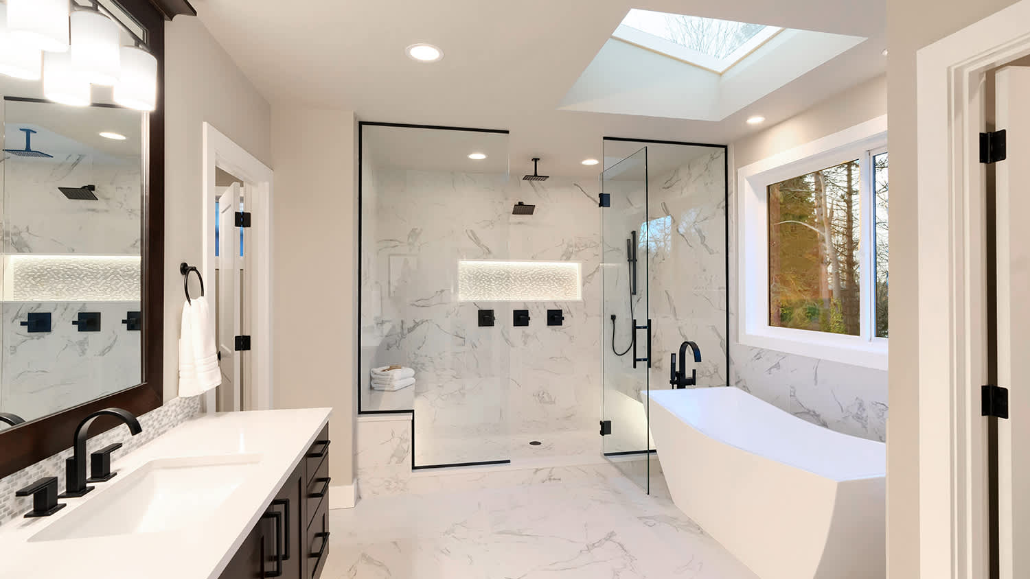 spacious white bathroom with skylight